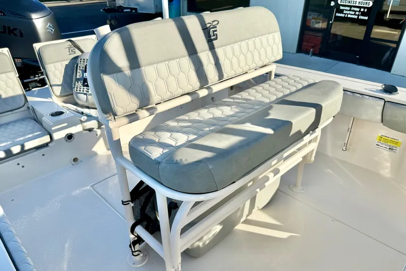 Slide: The Image of 2026 Carolina Skiff 24 Ultra Elite boat interior with cushioned seating and Suzuki engine. - 26