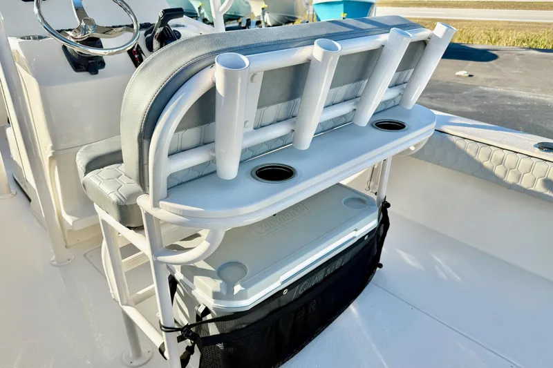 Slide: The Image of 2026 Carolina Skiff 24 Ultra Elite boat interior with rod holders and seating. - 29