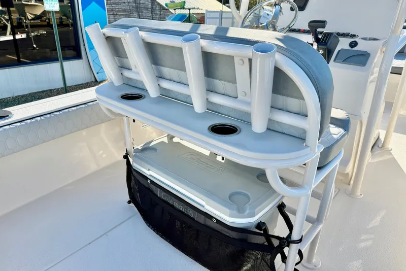 Slide: The Image of 2026 Carolina Skiff 24 Ultra Elite boat interior with rod holders and cooler storage. - 30