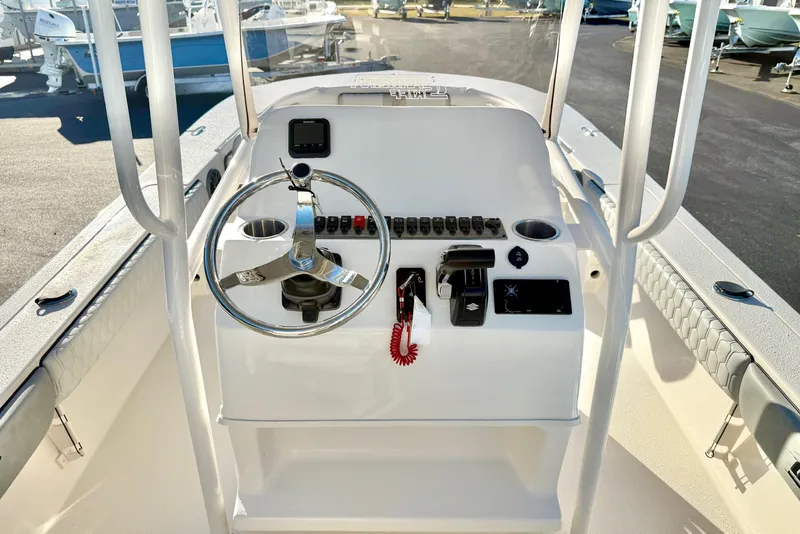 Slide: The Image of 2026 Carolina Skiff 24 Ultra Elite boat console with steering wheel and controls. - 31