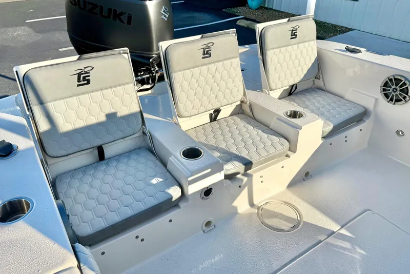 Slide: The Image of 2026 Carolina Skiff 24 Ultra Elite boat seats with cup holders and Suzuki engine. - 32