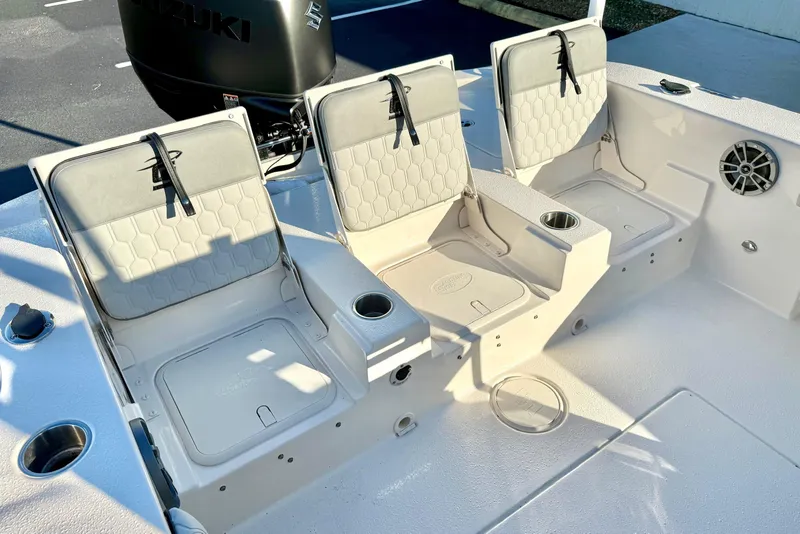 Slide: The Image of 2026 Carolina Skiff 24 Ultra Elite boat seating with storage and cup holders. - 33