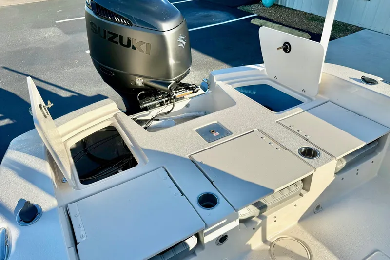 Slide: The Image of 2026 Carolina Skiff 24 Ultra Elite boat with Suzuki outboard motor and storage compartments. - 36