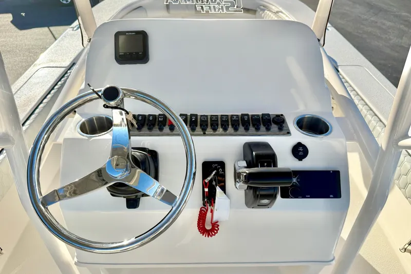Slide: The Image of Steering console of 2026 Carolina Skiff 24 Ultra Elite boat with controls and gauges. - 4