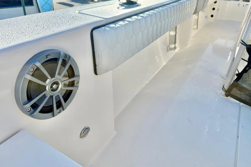 Slide: The Image of 2026 Carolina Skiff 24 Ultra Elite boat interior with speaker and cushioned side panel. - 41