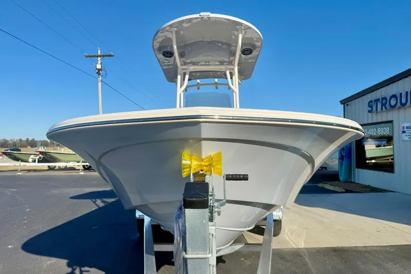 Slide: The Image of 2026 Carolina Skiff 24 Ultra Elite boat on trailer, sunny day, dealership background. - 9