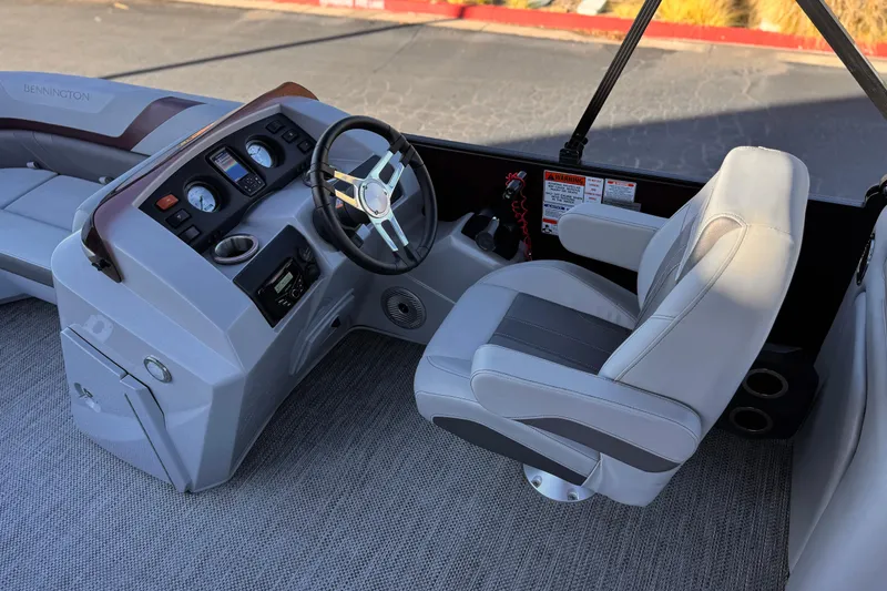 Slide: The Image of Captain's helm of 2023 Bennington 22 XSR boat with modern controls and seating. - 21