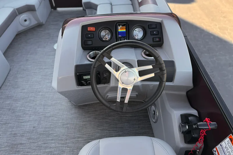 Slide: The Image of 2023 Bennington 22 XSR boat dashboard with steering wheel and control panel. - 22