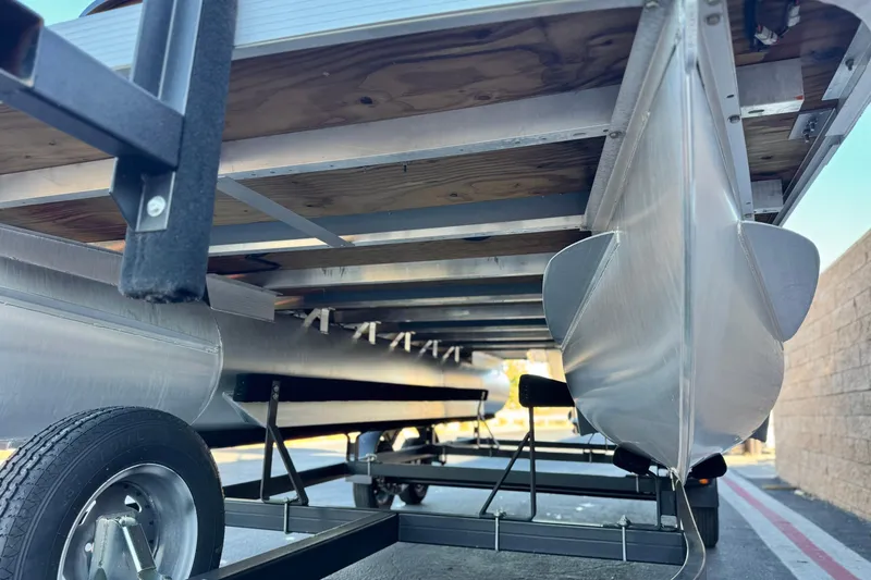 Slide: The Image of Underneath view of a 2023 Bennington 22 XSR pontoon boat on a trailer. - 4