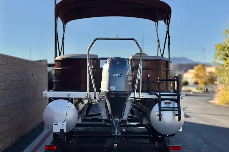 Slide: The Image of 2023 Bennington 22 XSR pontoon boat with Yamaha 115 engine, parked outdoors. - 5