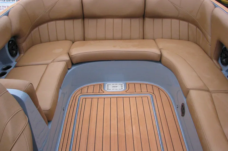 Slide: The Image of Luxurious interior of 2026 MB B52-23 Classic LIMITED boat with tan seating and wood flooring. - 11