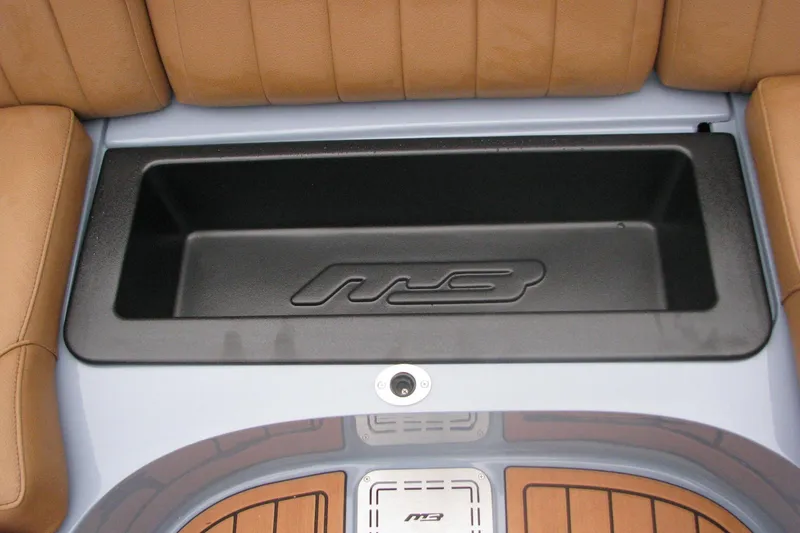 Slide: The Image of 2026 MB B52-23 Classic LIMITED boat interior with tan seating and storage compartment. - 17