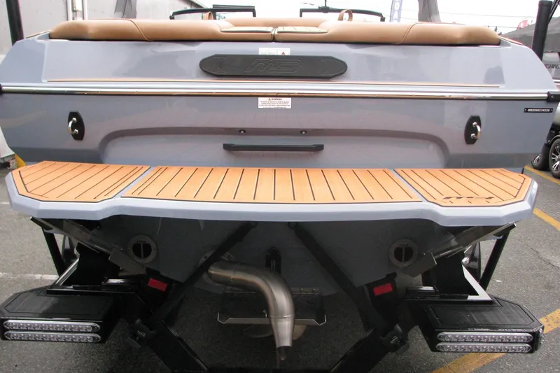 Slide: The Image of 2026 MB B52-23 Classic LIMITED boat rear view with teak swim platform. - 18
