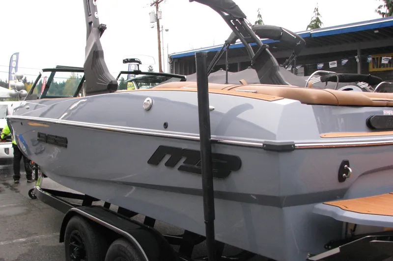 Slide: The Image of 2026 MB B52-23 Classic LIMITED boat on trailer, sleek design, outdoor display. - 2