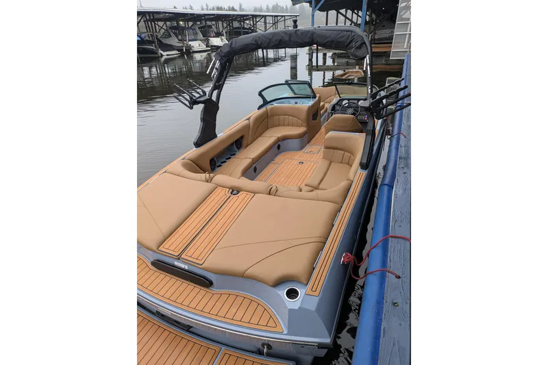 Slide: The Image of 2026 MB B52-23 Classic LIMITED boat with tan seating, docked at a marina. - 21