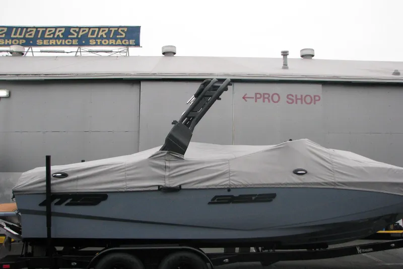 Slide: The Image of 2026 MB B52-23 Classic LIMITED boat covered, parked near pro shop. - 5