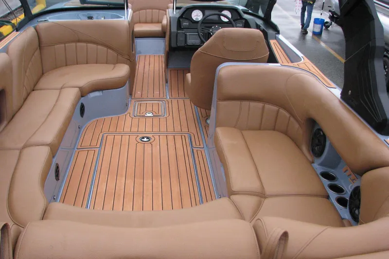 Slide: The Image of Interior of 2026 MB B52-23 Classic LIMITED boat with tan leather seating and wood flooring. - 7
