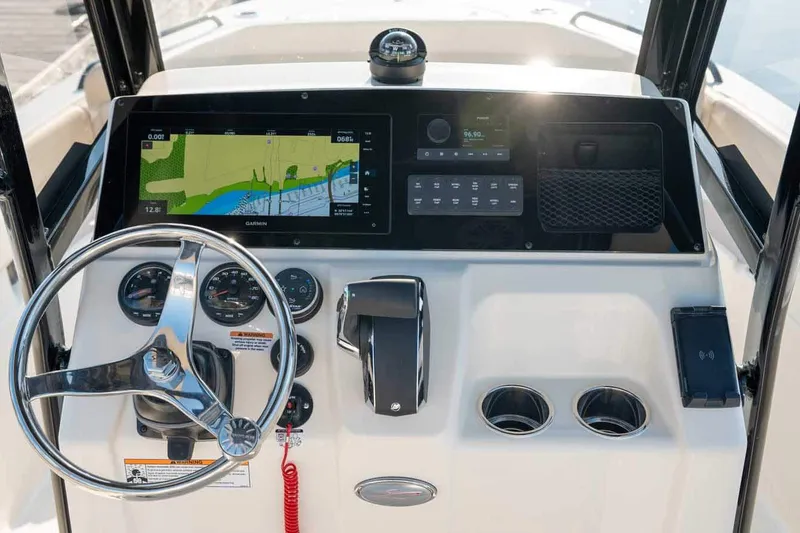 Slide: The Image of Manufacturer Provided Image: 2026 Scout 220 XSF boat dashboard with navigation screen and steering wheel. - 5