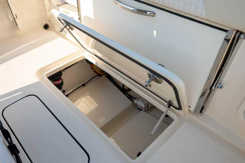 Slide: The Image of Manufacturer Provided Image: 2026 Scout 220 XSF boat storage compartment with open hatch, showcasing interior details. - 7