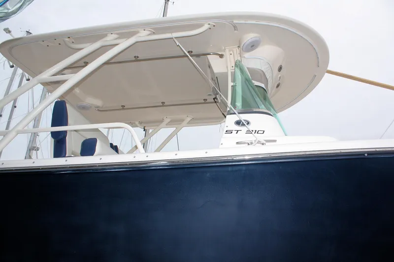 Slide: The Image of 2013 Pursuit ST 310 Sport boat, side view with canopy and seating. - 11