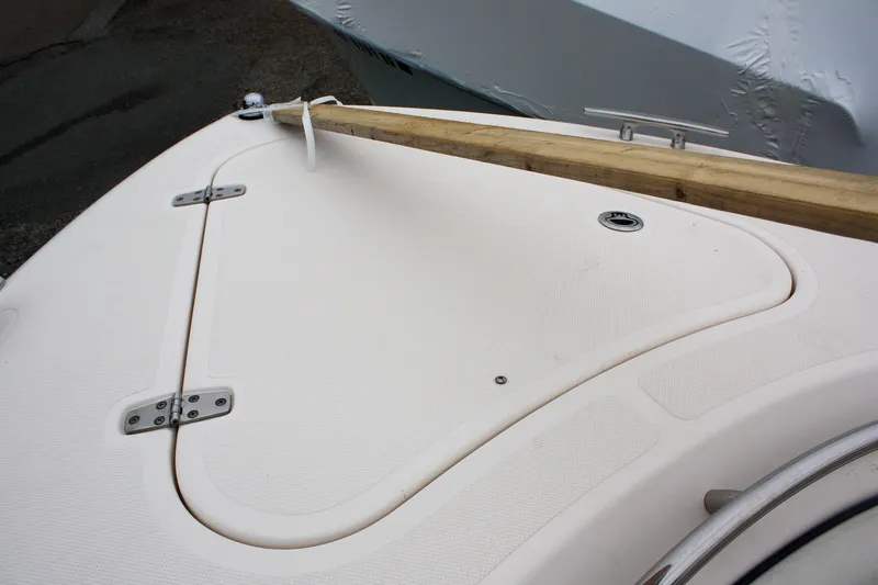 Slide: The Image of 2013 Pursuit ST 310 Sport boat deck with wooden beam and cleat. - 12
