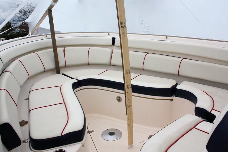 Slide: The Image of 2013 Pursuit ST 310 Sport boat interior with white and red cushioned seating. - 14