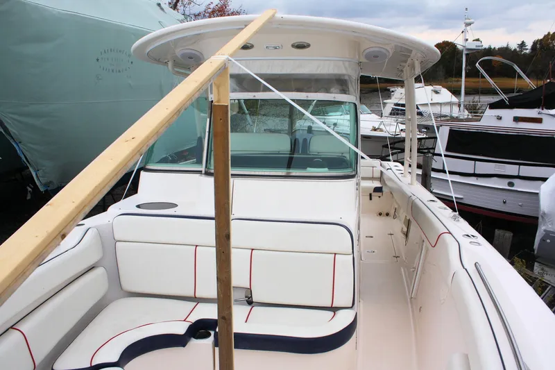 Slide: The Image of 2013 Pursuit ST 310 Sport boat with white seating and protective cover. - 16