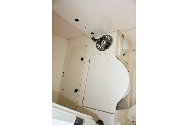 Slide: The Image of 2013 Pursuit ST 310 Sport boat interior with sink and storage compartments. - 21