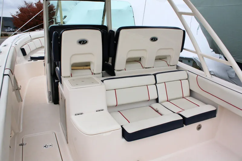 Slide: The Image of 2013 Pursuit ST 310 Sport boat interior with cushioned seating and helm chairs. - 25