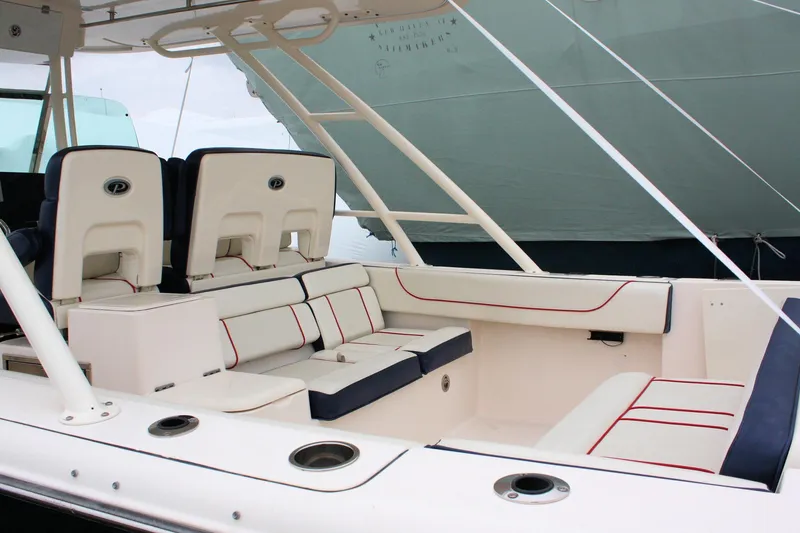 Slide: The Image of 2013 Pursuit ST 310 Sport boat interior with white and navy seating. - 27