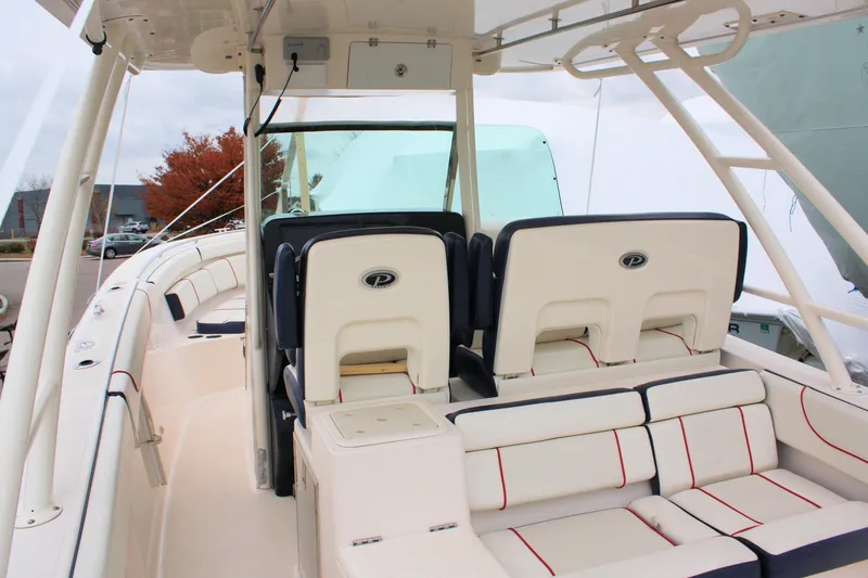 Slide: The Image of 2013 Pursuit ST 310 Sport boat interior with cushioned seating and helm station. - 28