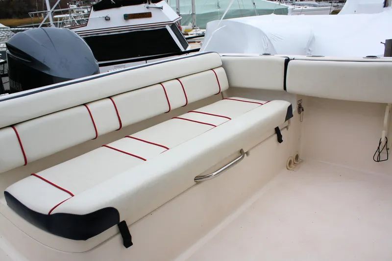 Slide: The Image of 2013 Pursuit ST 310 Sport boat interior with white seating and red accents. - 31