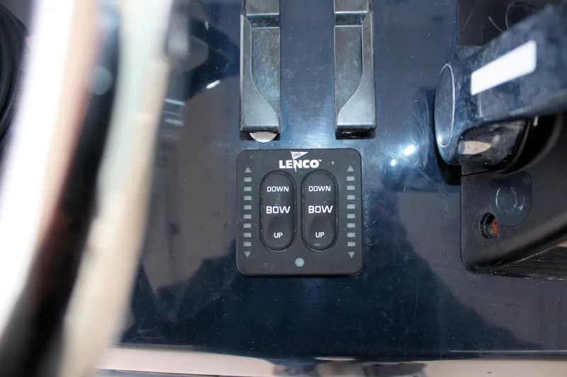 Slide: The Image of Control panel of a 2013 Pursuit ST 310 Sport boat with Lenco trim tab switches. - 32