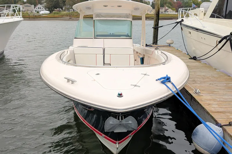 Slide: The Image of 2013 Pursuit ST 310 Sport boat docked at marina, front view. - 5