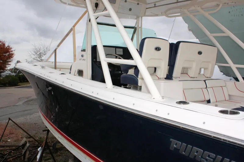 Slide: The Image of 2013 Pursuit ST 310 Sport boat with white seating and sleek design. - 9