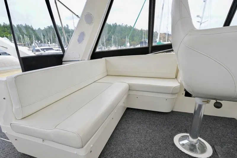 Slide: The Image of 2004 Meridian 490 Pilothouse interior with steering wheel and navigation equipment. - 13