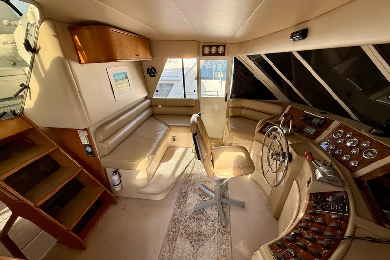 Slide: The Image of Luxurious interior of 2004 Meridian 490 Pilothouse with white seating and panoramic windows. - 16