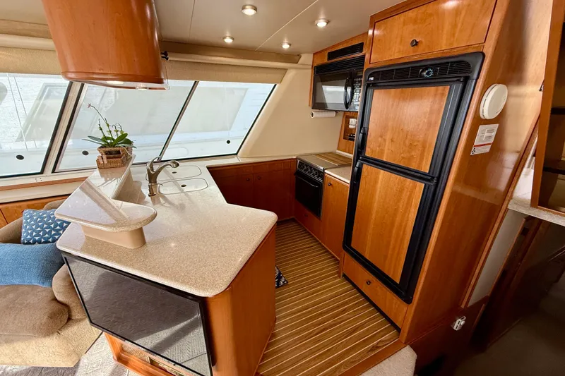 Slide: The Image of Luxurious interior of 2004 Meridian 490 Pilothouse yacht with plush seating and elegant decor. - 32