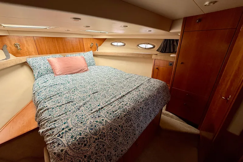 Slide: The Image of 2004 Meridian 490 Pilothouse kitchen with wood cabinetry, appliances, and stairs. - 37