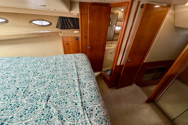 Slide: The Image of Luxurious bedroom interior of 2004 Meridian 490 Pilothouse yacht with elegant wood finish. - 39