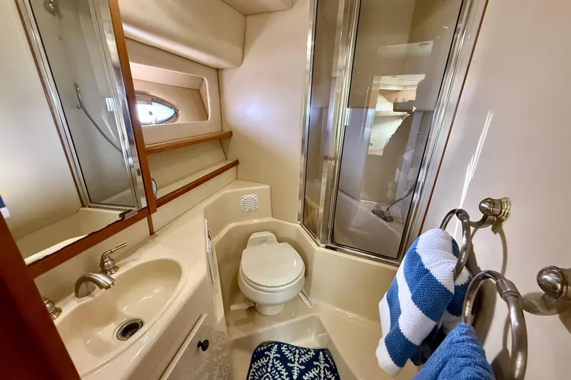 Slide: The Image of Luxurious cabin interior of 2004 Meridian 490 Pilothouse yacht with wood finish and patterned bedding. - 41