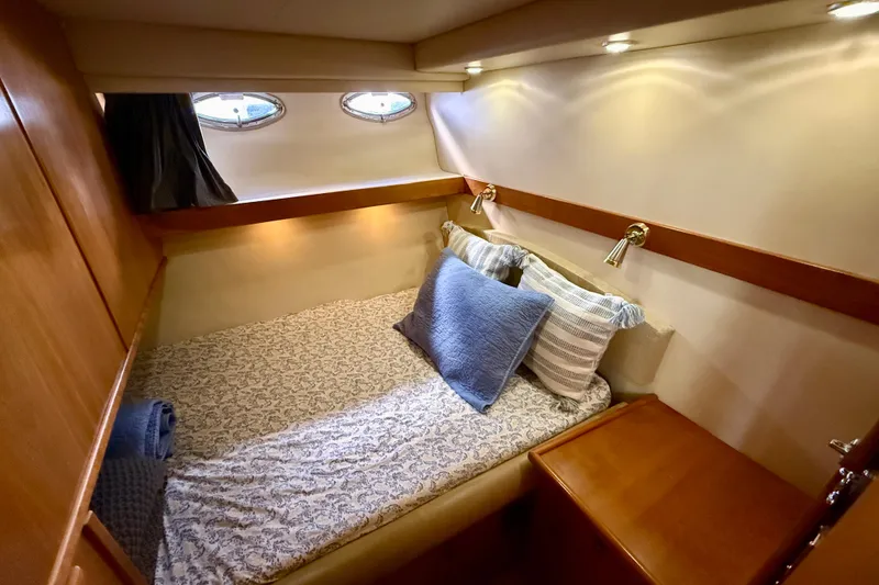 Slide: The Image of Luxurious 2004 Meridian 490 Pilothouse interior with wood finishes and cozy bedding. - 43