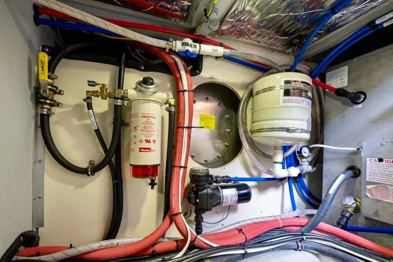 Slide: The Image of Engine room of 2004 Meridian 490 Pilothouse yacht, showcasing complex machinery and wiring. - 58