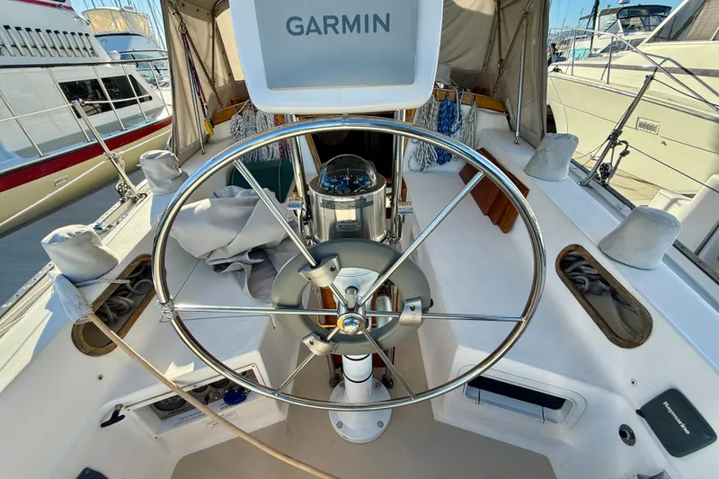 Slide: The Image of Cockpit of 1988 Catalina 36 sailboat with Garmin navigation system and steering wheel. - 13