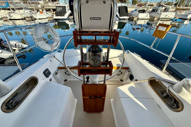 Slide: The Image of Cockpit of 1988 Catalina 36 sailboat with steering wheel and marina view. - 16
