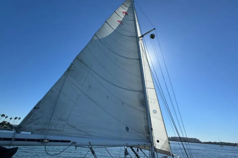 Slide: The Image of Sailboat Catalina 36 (1988) with full sail against clear blue sky. - 22