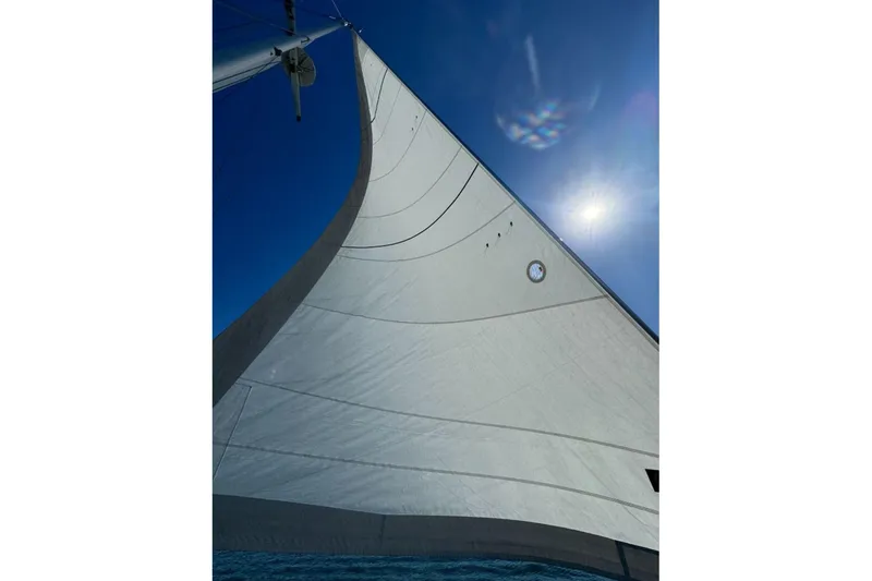 Slide: The Image of Sail of a 1988 Catalina 36 yacht against a clear blue sky. - 24