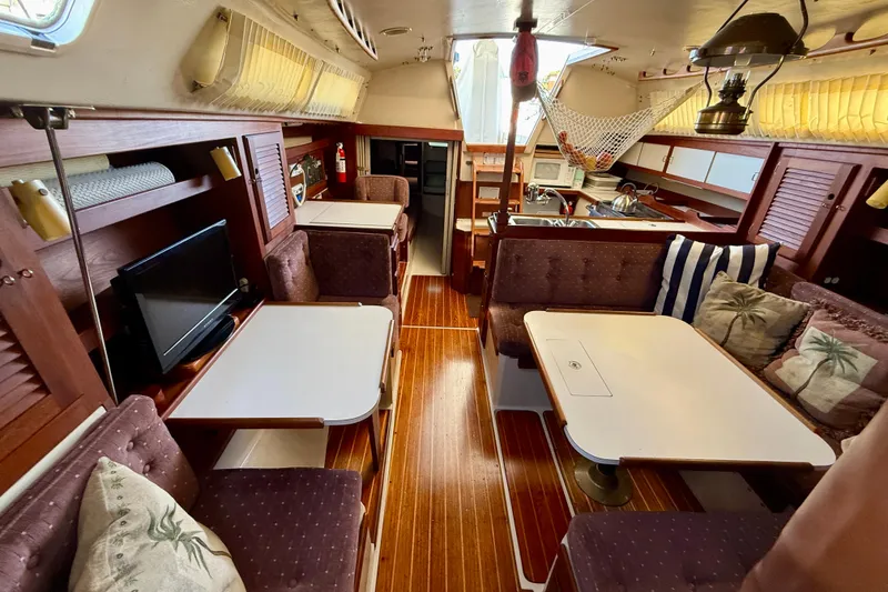 Slide: The Image of Interior of a 1988 Catalina 36 sailboat with cozy seating and wooden finishes. - 27