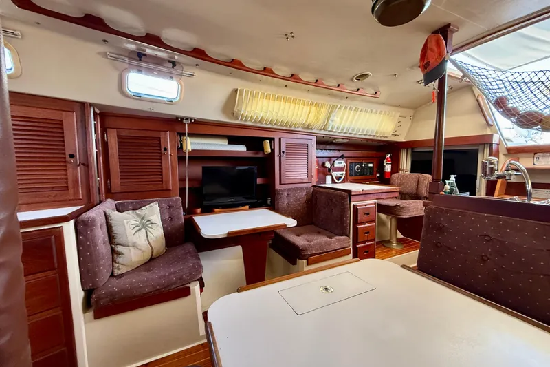 Slide: The Image of Interior of a 1988 Catalina 36 sailboat with cozy seating and wooden cabinetry. - 28