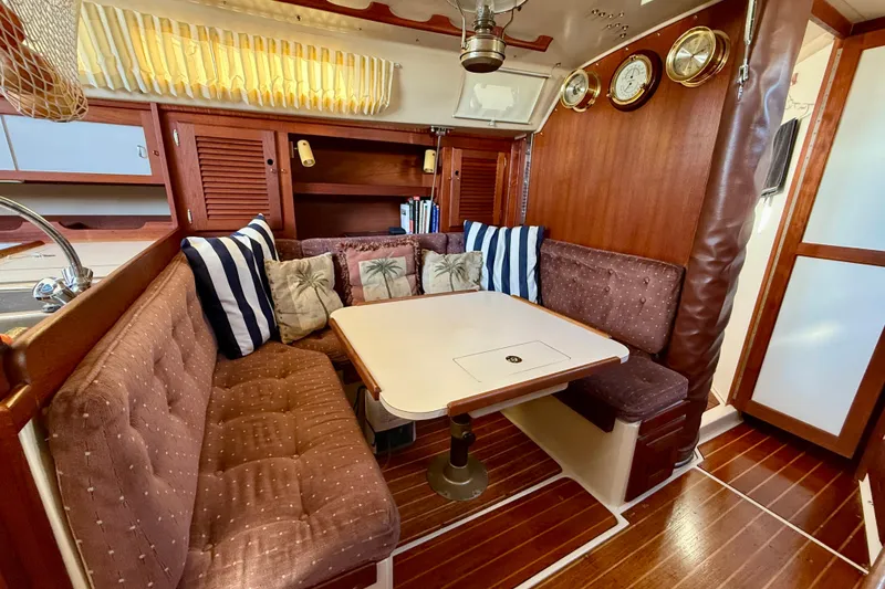 Slide: The Image of 1988 Catalina 36 yacht interior with cozy dining area and nautical decor. - 29